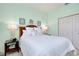Inviting bedroom with a queen bed, coastal decor, and a spacious closet at 523 Park Estates Sq, Venice, FL 34293