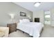 Well-lit bedroom featuring a comfortable bed with neutral-toned furnishings at 523 Park Estates Sq, Venice, FL 34293