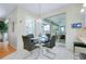 Dining area with a glass table, chrome chairs and natural light from the sliding glass doors at 523 Park Estates Sq, Venice, FL 34293