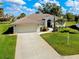 Charming single-story home with tile roof, manicured lawn and two car garage at 523 Park Estates Sq, Venice, FL 34293