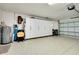 Spacious two car garage with epoxy flooring, lots of storage and water heater at 523 Park Estates Sq, Venice, FL 34293