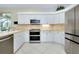 Bright kitchen featuring modern appliances, ample counter space, and a view of the dining area at 523 Park Estates Sq, Venice, FL 34293
