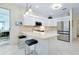 Bright kitchen features stainless steel appliances, stone countertops, and a breakfast bar at 523 Park Estates Sq, Venice, FL 34293