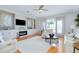 Spacious living room with custom built-ins, fireplace, large windows, and hardwood floors at 523 Park Estates Sq, Venice, FL 34293