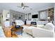 Cozy living room with fireplace and custom cabinetry in an open-concept layout, bright and airy at 523 Park Estates Sq, Venice, FL 34293