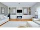 Elegant living room with built-in shelves, a fireplace, and a large-screen TV at 523 Park Estates Sq, Venice, FL 34293