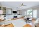Elegant living room with fireplace, ceiling fan, built-in shelving and bright natural light at 523 Park Estates Sq, Venice, FL 34293
