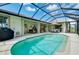 Enjoy this screened-in pool with ample seating for entertaining, and a lush backyard at 523 Park Estates Sq, Venice, FL 34293