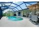 Screened-in pool with patio seating, perfect for outdoor relaxation and entertaining at 523 Park Estates Sq, Venice, FL 34293