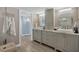 Elegant bathroom with double vanities and a large shower at 550 W Flamingo # 401, Venice, FL 34285
