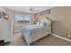 Bright bedroom with large window, neutral decor, and ceiling fan at 550 W Flamingo # 401, Venice, FL 34285