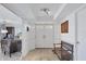 Bright entryway with tiled floors, bench, and access to office at 550 W Flamingo # 401, Venice, FL 34285