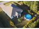 Aerial view showcasing house, pool, and surrounding landscape at 5550 Eyerly Ter, Port Charlotte, FL 33981