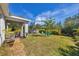 Backyard view showing a covered patio, pool, and grassy area at 5550 Eyerly Ter, Port Charlotte, FL 33981