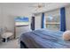 Bright bedroom featuring a comfortable bed and large TV at 5550 Eyerly Ter, Port Charlotte, FL 33981