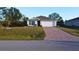 Single-story home with a paved driveway and well-manicured lawn at 5550 Eyerly Ter, Port Charlotte, FL 33981