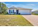 One-story home with a two-car garage and a brick paver driveway at 5550 Eyerly Ter, Port Charlotte, FL 33981