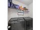 Convenient laundry room with washer, dryer, and shelving at 5550 Eyerly Ter, Port Charlotte, FL 33981