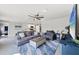 Open living room with gray sectional sofa and large TV at 5550 Eyerly Ter, Port Charlotte, FL 33981
