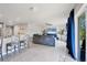 Spacious living room with gray sofas, a large TV, and ceiling fan at 5550 Eyerly Ter, Port Charlotte, FL 33981