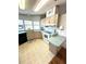 Kitchen features white appliances and light wood cabinets at 563 Portside Dr, North Port, FL 34287