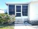 Steps leading to a well-maintained screened porch at 563 Portside Dr, North Port, FL 34287