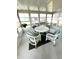 Bright and airy sunroom with white wicker furniture at 563 Portside Dr, North Port, FL 34287