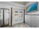 Bedroom featuring a large mirror and access to a pool view at 5891 Madison Rd, Venice, FL 34293