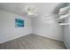 Bedroom with gray walls, ceiling fan and floating shelves at 5891 Madison Rd, Venice, FL 34293