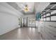 Bright bedroom with tiled floors, ceiling fan, and built-in shelving at 5891 Madison Rd, Venice, FL 34293