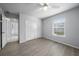 Bright bedroom featuring wood-look floors and double doors at 5891 Madison Rd, Venice, FL 34293
