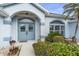 House exterior featuring a light blue facade and arched entryway at 5891 Madison Rd, Venice, FL 34293