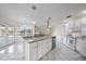 Bright kitchen with white cabinets, granite countertops, and stainless steel appliances at 5891 Madison Rd, Venice, FL 34293