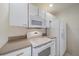 Bright kitchen with white cabinets and granite countertops at 5891 Madison Rd, Venice, FL 34293