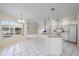 Bright kitchen with white cabinets, granite countertops, and stainless steel appliances at 5891 Madison Rd, Venice, FL 34293