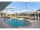 Inviting screened pool with brick coping and a relaxing view at 5891 Madison Rd, Venice, FL 34293