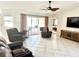 Living room with tiled floors, recliner chairs, and TV at 6 Pinehurst Rd, Rotonda West, FL 33947