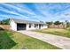 Front view of a house with a driveway and grassy yard at 606 School St, Venice, FL 34285