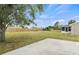 Spacious backyard with large grassy area and concrete patio at 6232 Drucker Cir, Port Charlotte, FL 33981