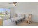 Well-lit bedroom with large window, tiled floors and a folding bed at 6232 Drucker Cir, Port Charlotte, FL 33981