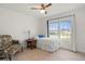 Bright bedroom featuring tiled floors and a ceiling fan at 6232 Drucker Cir, Port Charlotte, FL 33981