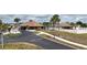 Community clubhouse with pool, palm trees, and covered seating areas at 6232 Drucker Cir, Port Charlotte, FL 33981