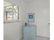 Bright entryway with blue cabinet, artwork, and window seat at 6232 Drucker Cir, Port Charlotte, FL 33981