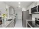 Modern kitchen with gray cabinets, granite countertops, and stainless steel appliances at 6232 Drucker Cir, Port Charlotte, FL 33981