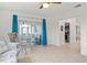 Bright sunroom with tiled floor, wicker furniture, and access to a screened porch at 6232 Drucker Cir, Port Charlotte, FL 33981