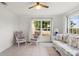 Sunroom with tiled floor, wicker furniture, and large windows at 6232 Drucker Cir, Port Charlotte, FL 33981