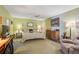 Bright bedroom with king-size bed, dresser, and seating area at 740 Citrus Rd, Venice, FL 34293