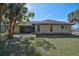 Rear view of house showcasing screened patio and yard at 740 Citrus Rd, Venice, FL 34293