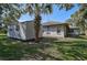 View of house exterior with storage shed and landscaping at 740 Citrus Rd, Venice, FL 34293