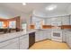 Galley kitchen with white cabinets and black appliances at 740 Citrus Rd, Venice, FL 34293